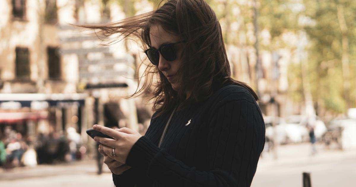 Woman Scrolling on Smartphone