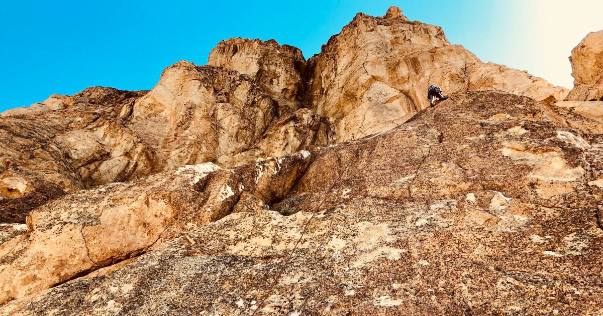 Ambitious Hiker Climbing Mountain