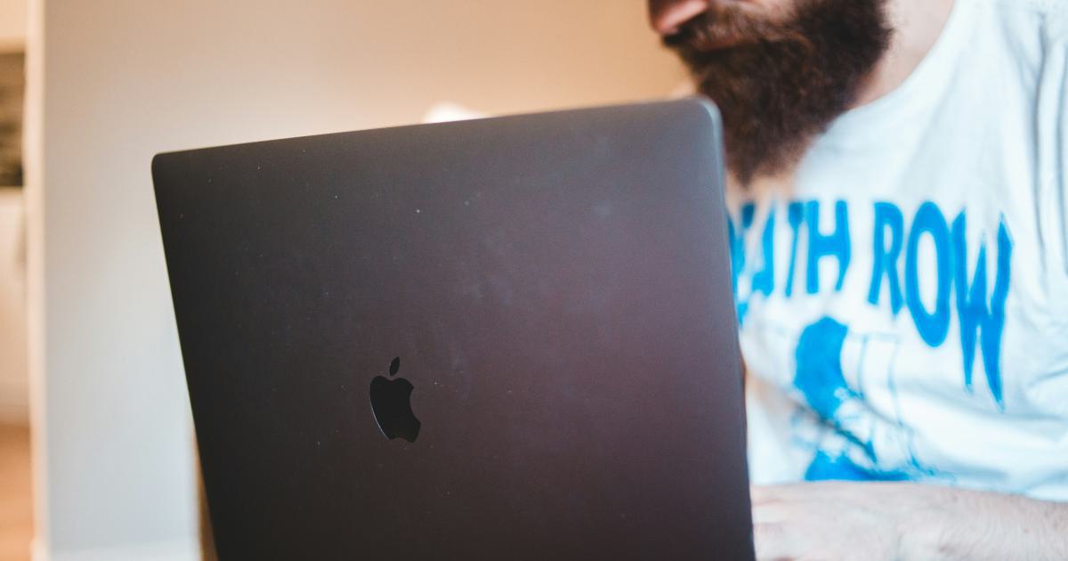 Man Writing on Laptop