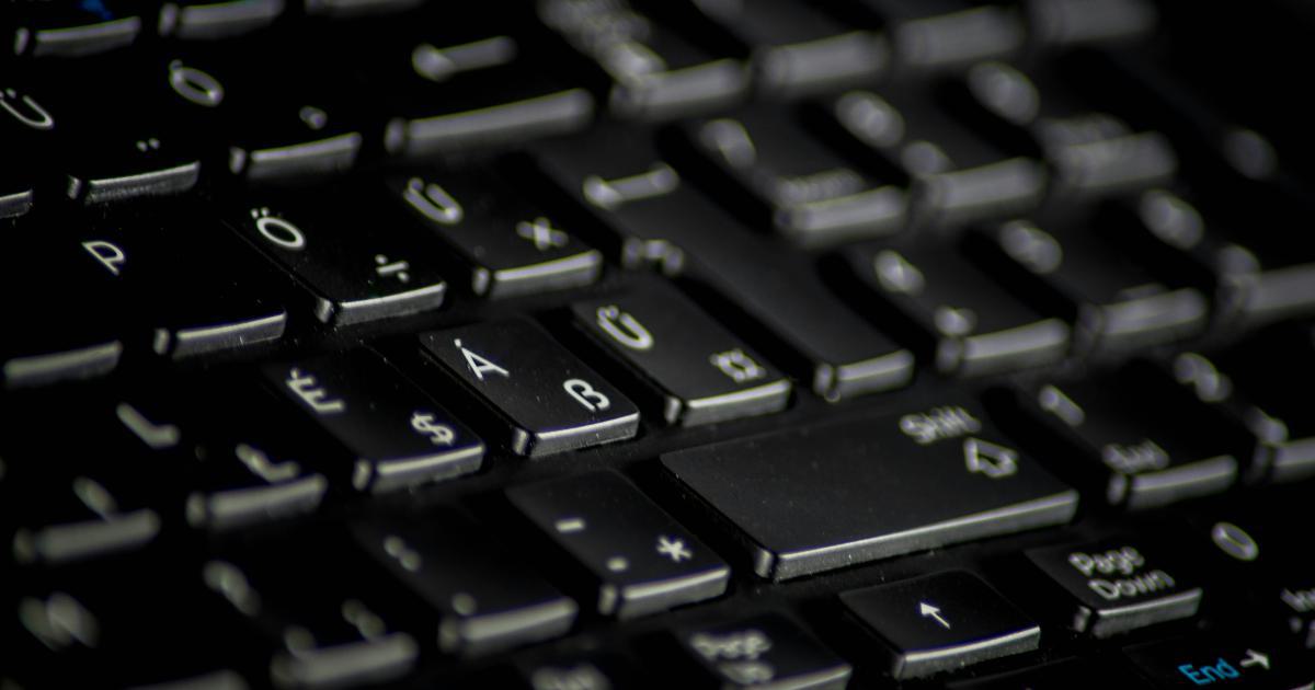 Hands Typing on Laptop Keyboard