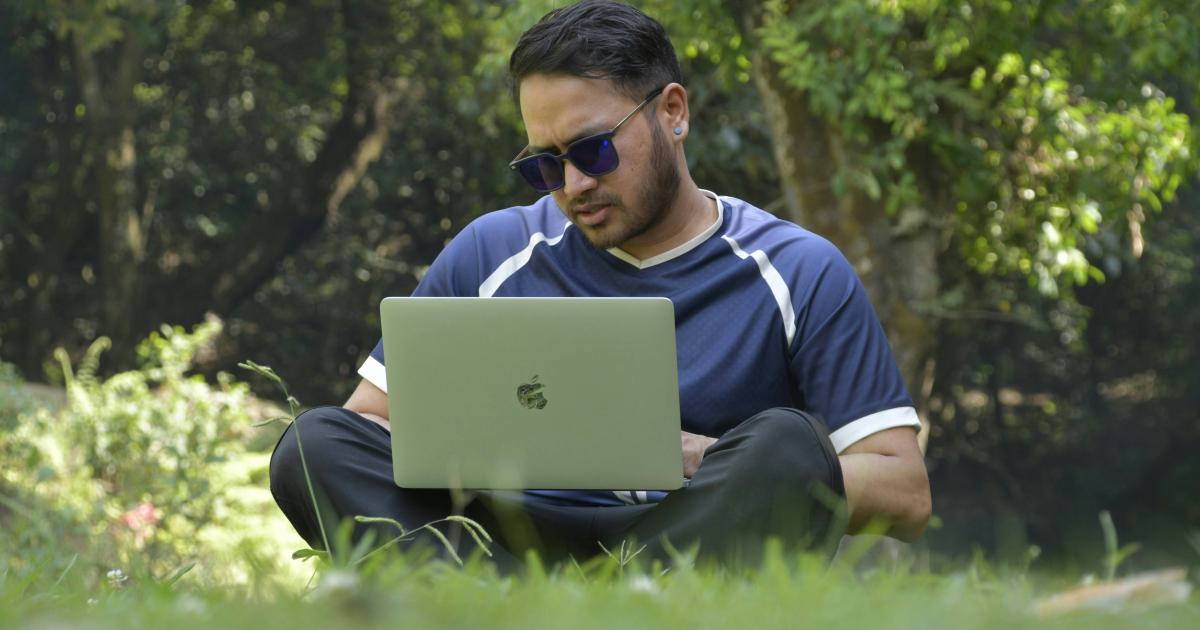 Person Analyzing Keyword Data on Laptop