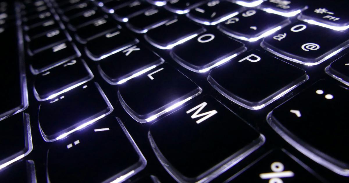 A close-up image of a person's hands typing on a keyboard