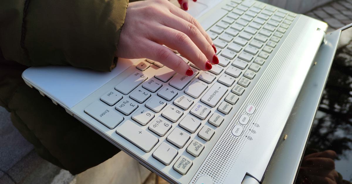 Hands Typing on Laptop