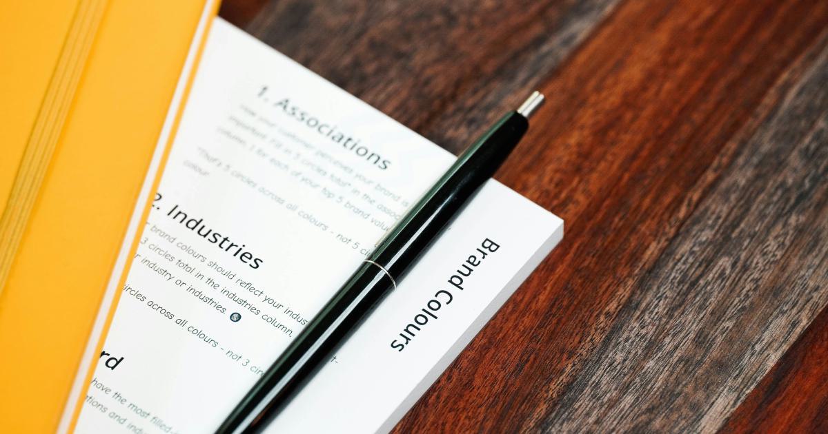 Business Person Writing on Notepad