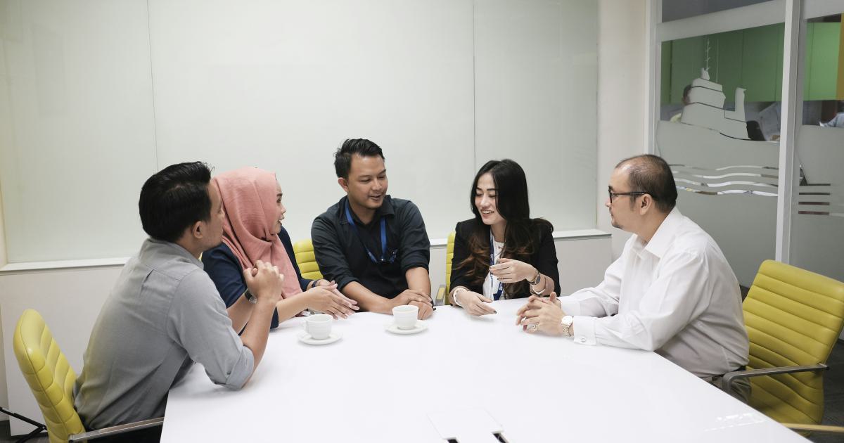 Diverse People Discussing around a Table