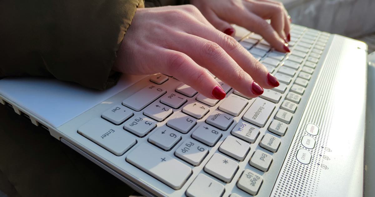 Woman Typing on Laptop