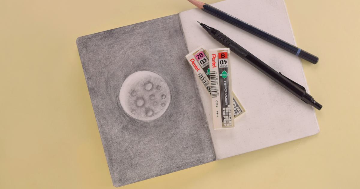 Notebook and Pencil on Desk
