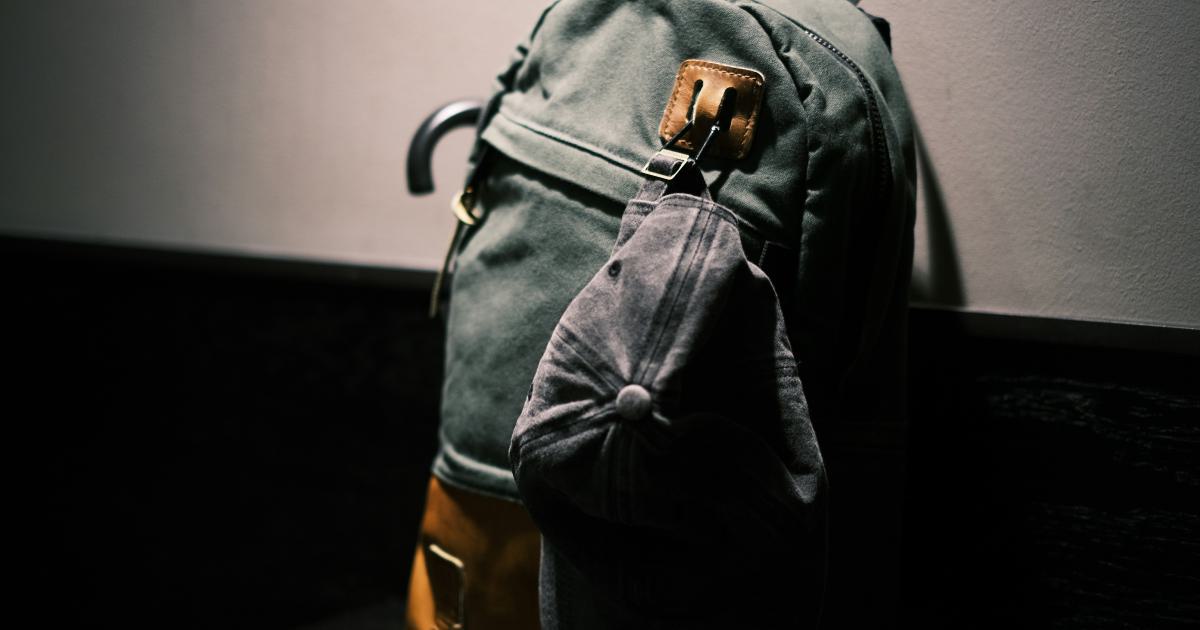 Woman Packing Backpack in Forest